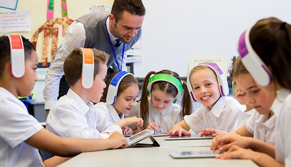 students listening to Reading Eggs in classroom